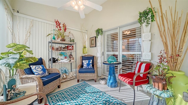 living area with ceiling fan and light tile patterned floors