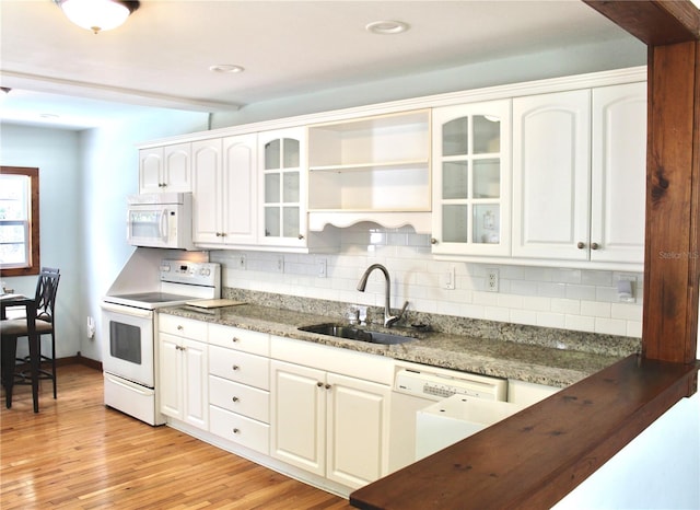 kitchen with sink, white cabinetry, white appliances, and light hardwood / wood-style floors