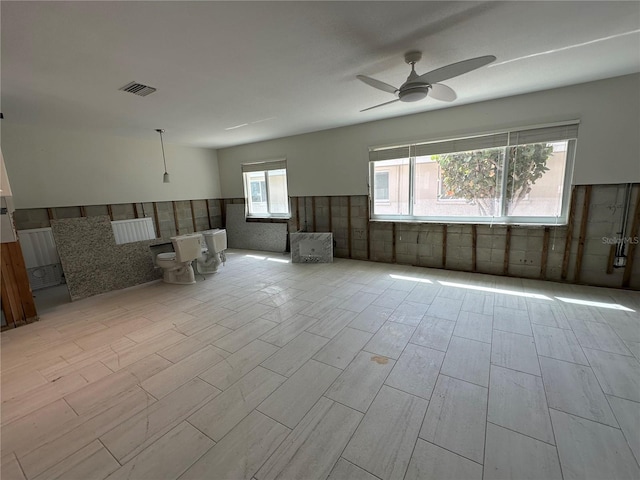 spare room with a healthy amount of sunlight and ceiling fan