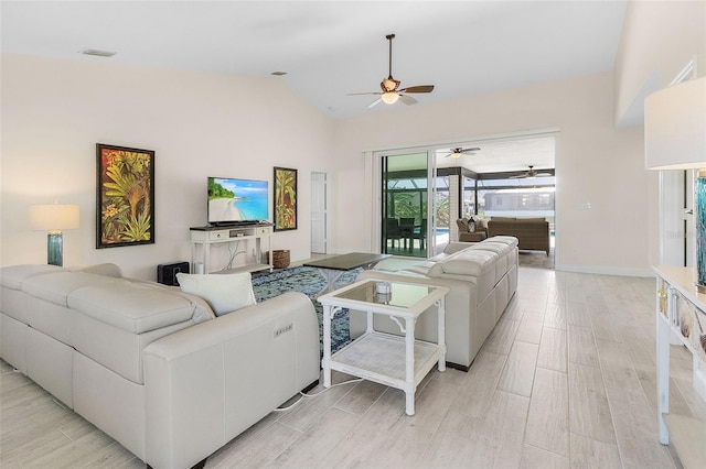 living room featuring light hardwood / wood-style floors, high vaulted ceiling, and ceiling fan