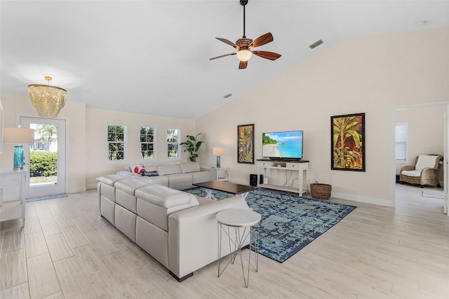 living room featuring light hardwood / wood-style floors, high vaulted ceiling, and ceiling fan with notable chandelier