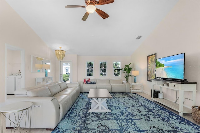 living room featuring high vaulted ceiling, washer and clothes dryer, wood-type flooring, and ceiling fan with notable chandelier