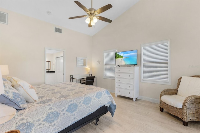 bedroom with light hardwood / wood-style floors, ensuite bath, high vaulted ceiling, and ceiling fan