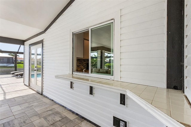 view of home's exterior featuring a patio and a lanai