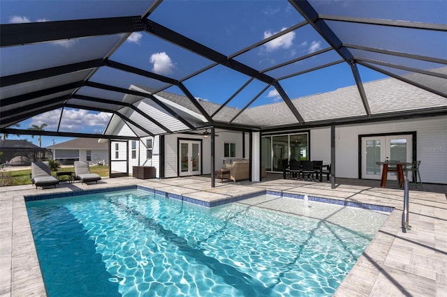 view of pool with french doors, ceiling fan, a patio area, and a lanai