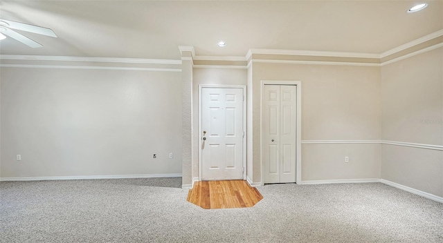 unfurnished bedroom featuring ornamental molding, carpet floors, and ceiling fan