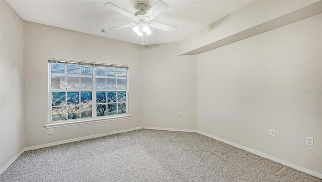 empty room with ceiling fan and carpet floors