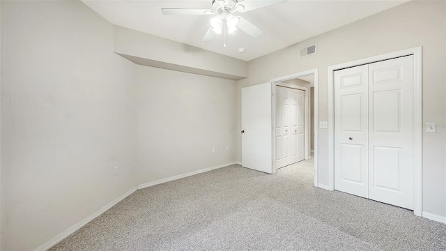 unfurnished bedroom featuring ceiling fan and light colored carpet