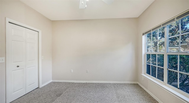 unfurnished bedroom with a closet, carpet flooring, and ceiling fan