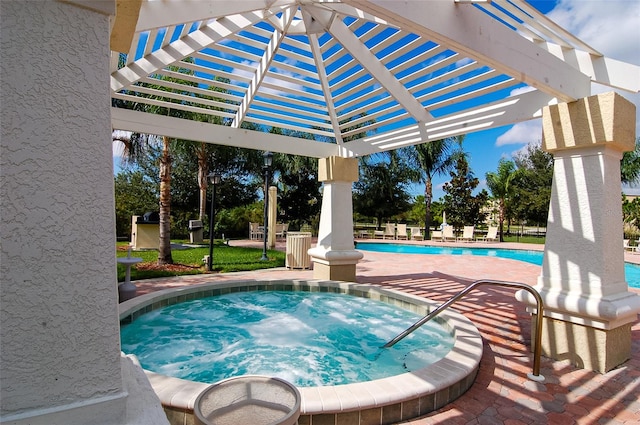 view of swimming pool featuring a pergola and a hot tub