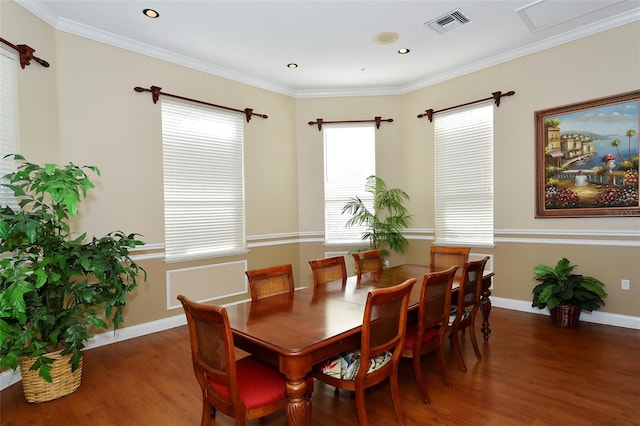 dining area with crown molding and dark hardwood / wood-style flooring