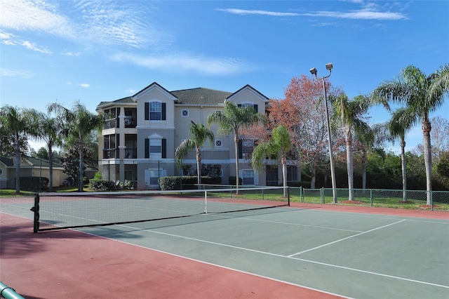 view of tennis court featuring basketball hoop