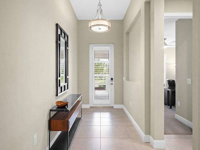 entryway featuring light tile patterned floors and ceiling fan