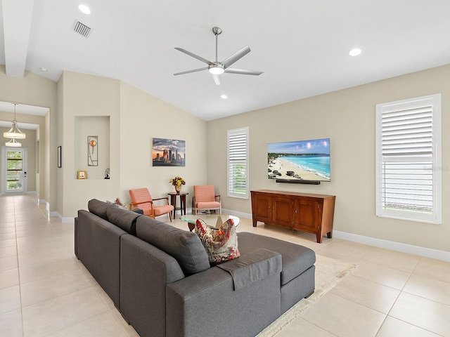 living room featuring ceiling fan, light tile patterned floors, and vaulted ceiling