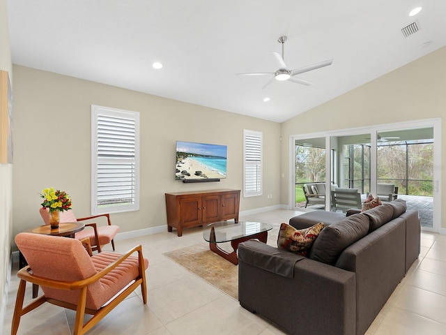 living room with ceiling fan, light tile patterned flooring, and lofted ceiling