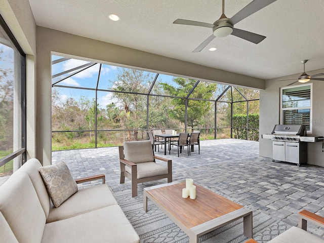 exterior space featuring an outdoor hangout area, ceiling fan, a lanai, and grilling area