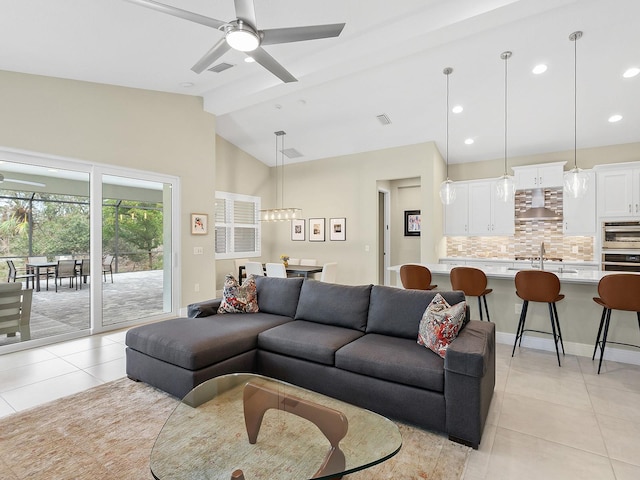 tiled living room featuring lofted ceiling with beams and ceiling fan