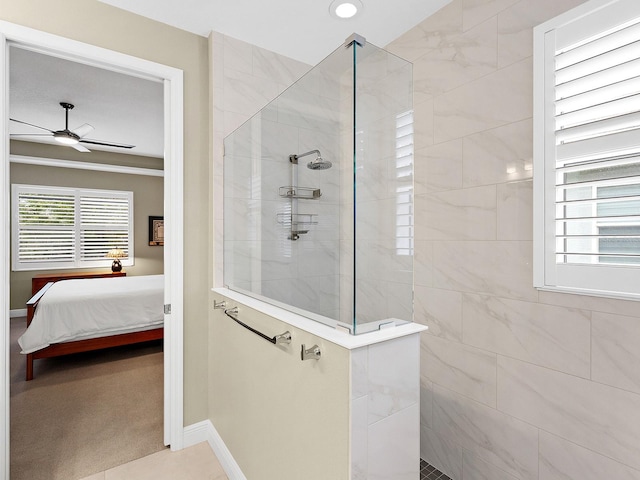 bathroom featuring a tile shower and ceiling fan