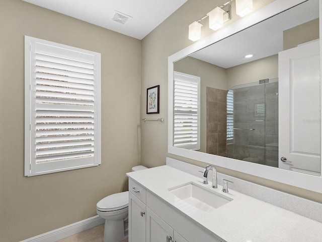 bathroom featuring toilet, tile patterned flooring, vanity, and walk in shower