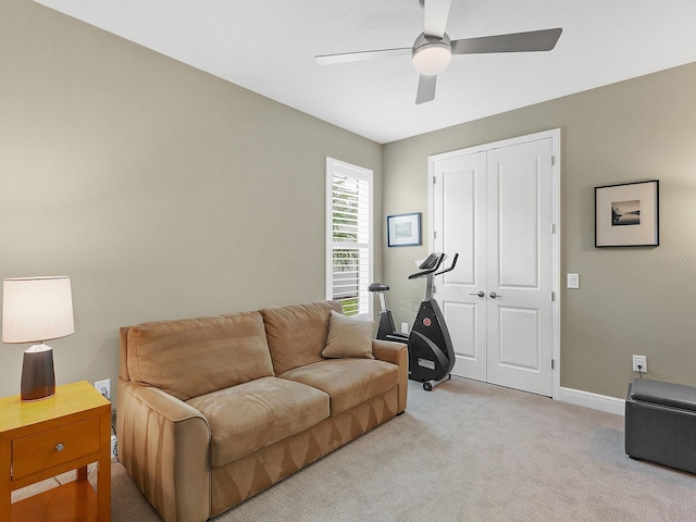 carpeted living room featuring ceiling fan