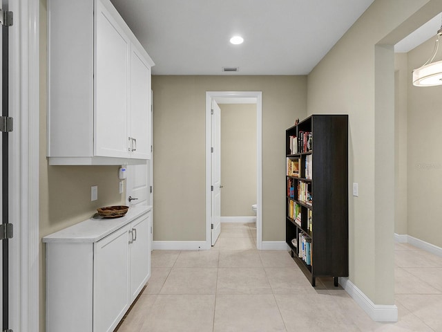 corridor featuring light tile patterned floors