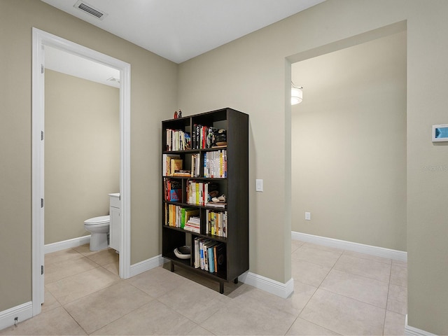 corridor with light tile patterned floors