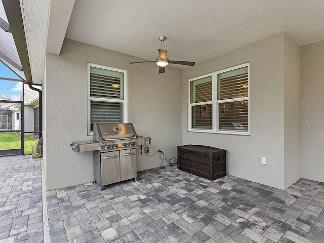 view of patio / terrace featuring area for grilling, ceiling fan, and a lanai