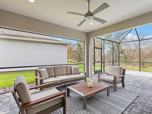 sunroom featuring ceiling fan