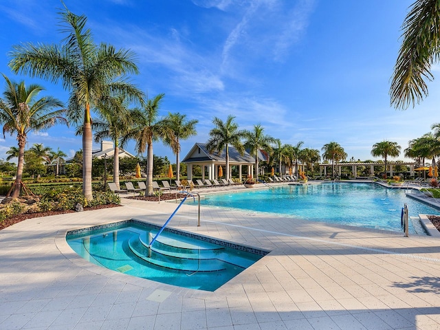 view of pool with a community hot tub and a patio