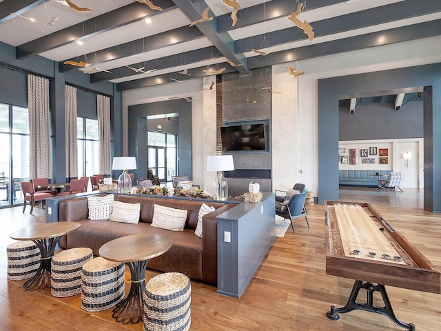 interior space featuring beam ceiling and light hardwood / wood-style flooring