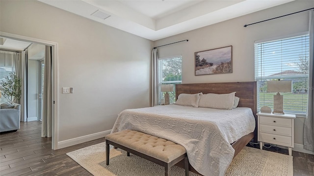 bedroom with dark hardwood / wood-style floors