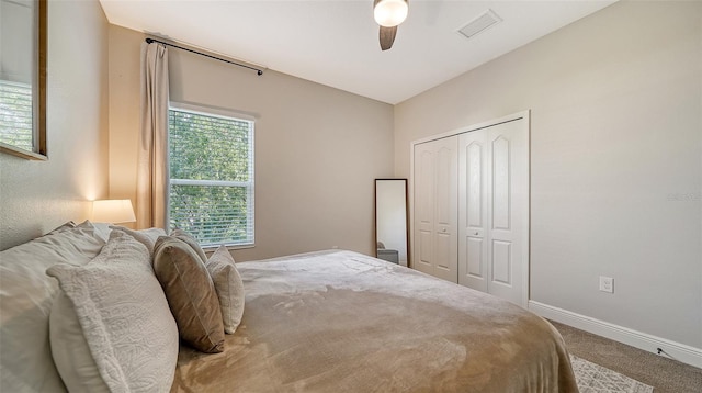 carpeted bedroom with a closet and ceiling fan