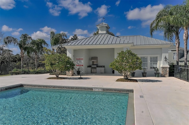 rear view of property with a patio area and a fenced in pool