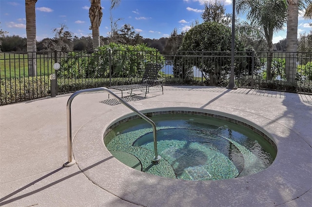 view of swimming pool featuring a hot tub and a patio area