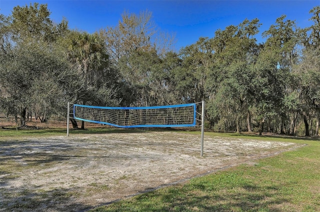 view of home's community featuring a yard and volleyball court