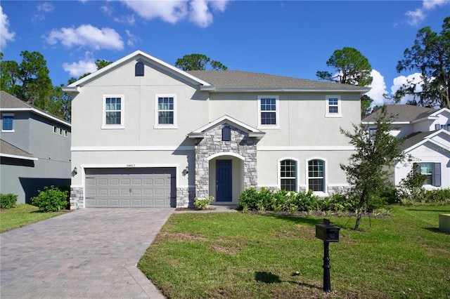 view of front of house with a garage and a front lawn