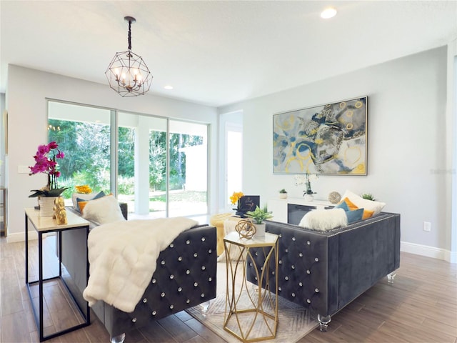 living room featuring hardwood / wood-style flooring and an inviting chandelier