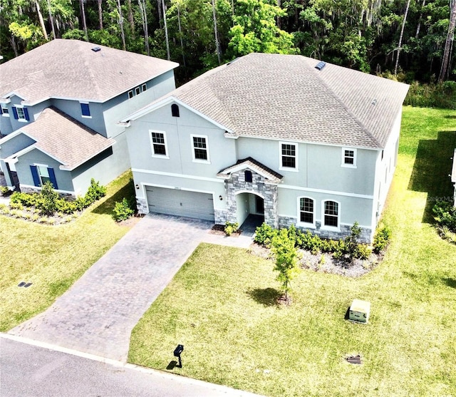 view of front of property featuring a front lawn and a garage