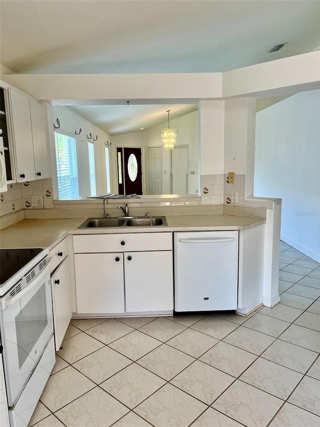 kitchen with lofted ceiling, sink, white cabinetry, white appliances, and tasteful backsplash