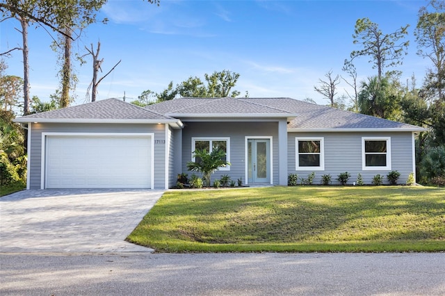 single story home with a front yard and a garage