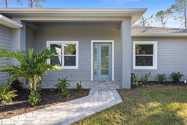 doorway to property with a lawn