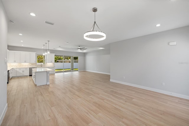 interior space with sink, light wood-type flooring, and ceiling fan