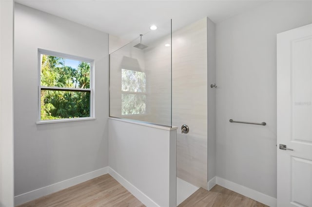 bathroom featuring hardwood / wood-style floors and walk in shower