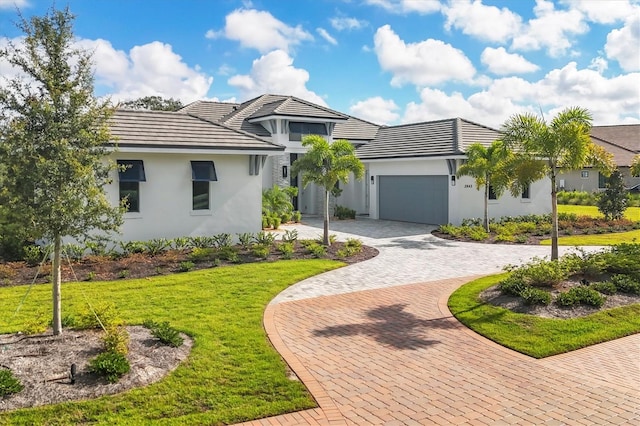 view of front facade with a garage and a front lawn