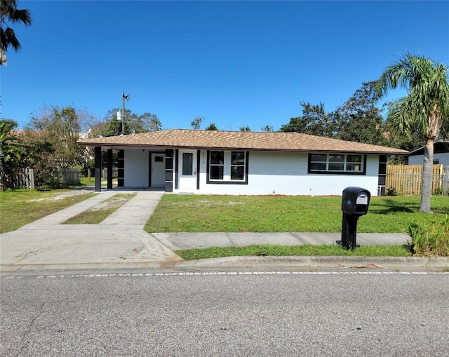 ranch-style house with a front yard and a carport