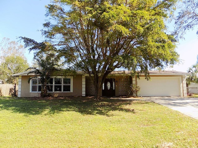 ranch-style house featuring a garage and a front lawn