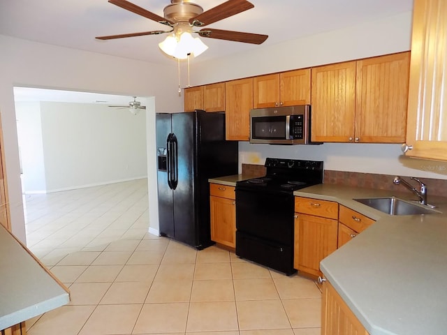 kitchen with sink, black appliances, light tile patterned flooring, and ceiling fan