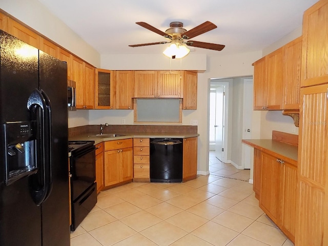 kitchen with sink, black appliances, light tile patterned flooring, and ceiling fan