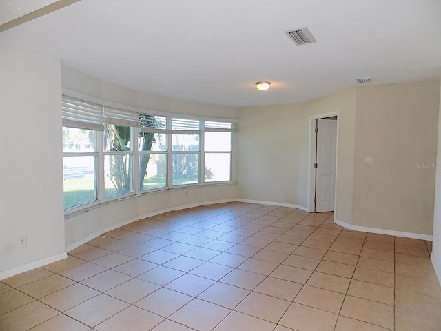 tiled empty room with a healthy amount of sunlight