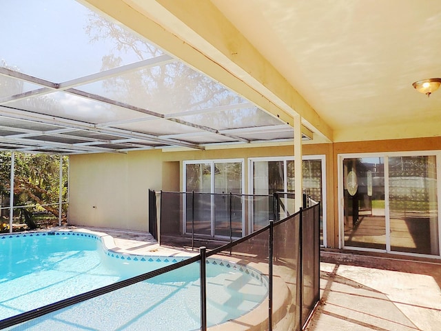 view of swimming pool with a lanai and a patio area